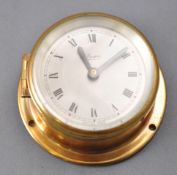An English (Marpro) brass ship's bulkhead clock, of traditional design, with a sillvered Roman dial,