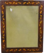A rectangular wall mirror with Dutch style frame inlaid with scrolling flowering branches,