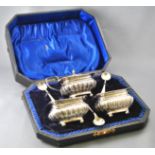 A cased six piece cruet set, comprising a silver covered mustard and two salts,