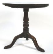 A Provincial mahogany and oak tripod tea table, the tilt-top circular table above a baluster stem,