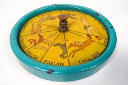 A horse racing gaming wheel, each segment painted with a named race horse,