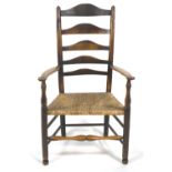 An oak ladder back armchair with rush seat, 19th century,