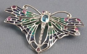 A silver brooch set with topaz, rubies, coloured enamel and marcasite