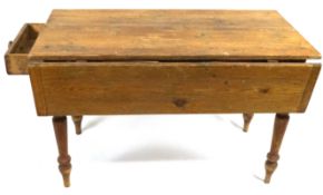 A pine Pembroke table with two frieze drawers on turned tapering legs,