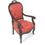 A 19th century mahogany framed armchair, the shield shaped back with pierced carved crest,