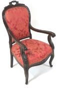 A 19th century mahogany framed armchair, the shield shaped back with pierced carved crest,