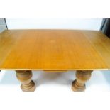 A large oak draw leaf dining table on baluster legs on octagonal block feet,