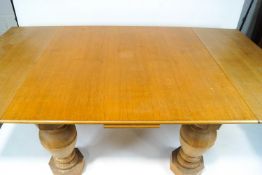 A large oak draw leaf dining table on baluster legs on octagonal block feet,