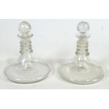 A pair of heavy plain glass Rodney or Ship's decanters.