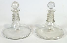 A pair of heavy plain glass Rodney or Ship's decanters.
