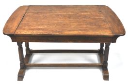 An early 20th century oak metamorphic dining table/sofa with ivorine label,