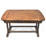 An early 20th century oak metamorphic dining table/sofa with ivorine label,