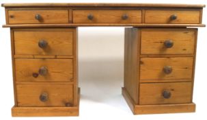 A pine pedestal desk with plain galleried top above three frieze drawers,