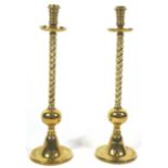 A pair of heavy brass candlesticks,
