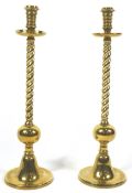 A pair of heavy brass candlesticks,