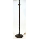 A mahogany standard lamp, of baluster form with beaded borders on round stepped base,