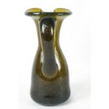 A 19th century glass jug with applied scroll handle, the concave underside with pontil mark,