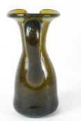 A 19th century glass jug with applied scroll handle, the concave underside with pontil mark,