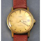A gold plated Omega Geneve wristwatch. Circular gold dial with baton markings and date feature.