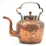 A 19th century large copper kettle with strap handle,