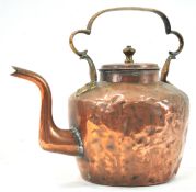 A 19th century large copper kettle with strap handle,