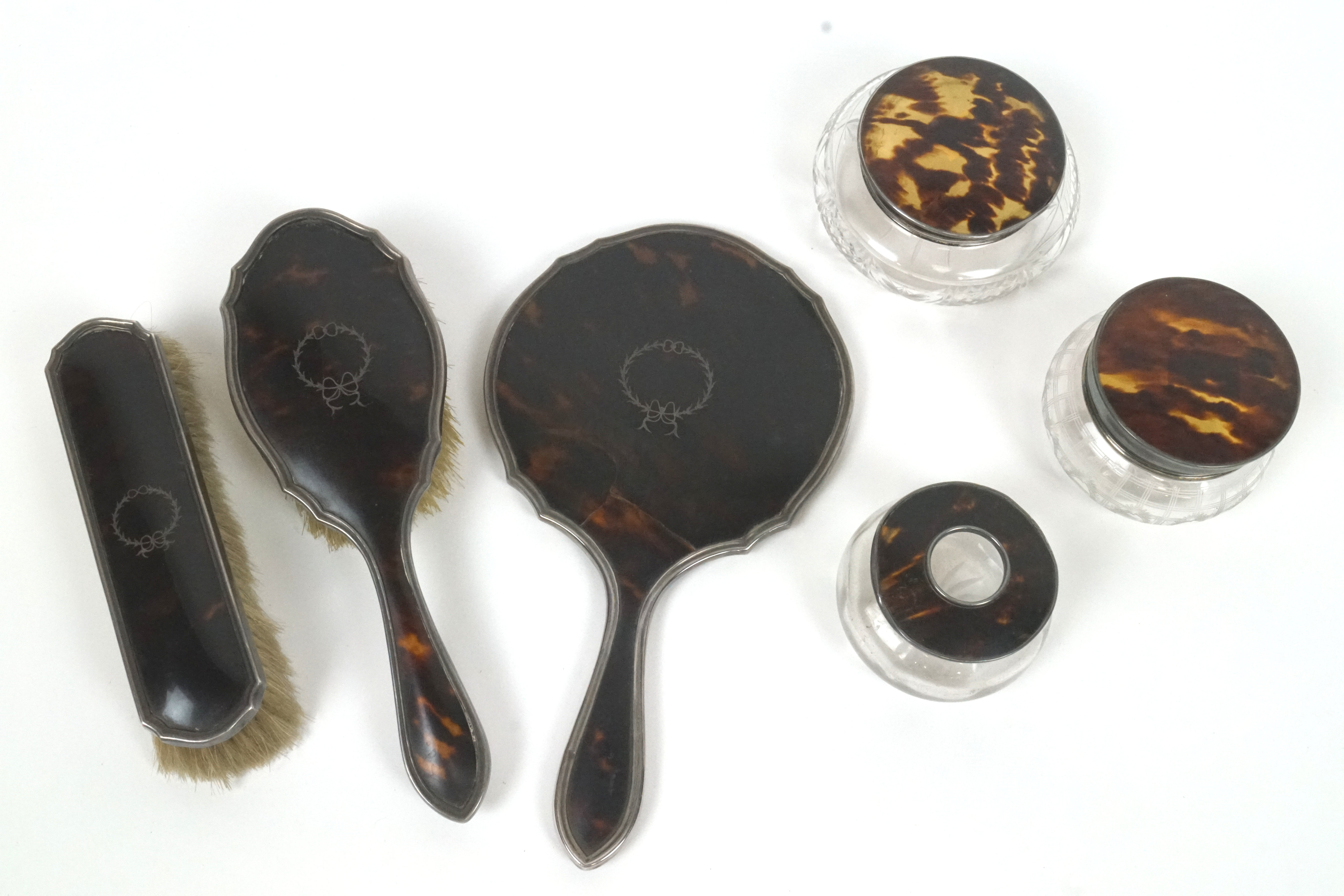 A silver and tortoiseshell Harlequin dressing table set,