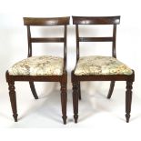 Two William IV mahogany dining chairs, with shaped bar backs above reeded splats,