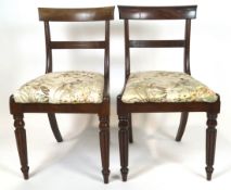 Two William IV mahogany dining chairs, with shaped bar backs above reeded splats,