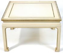 A square white painted coffee table with inset glass top on Chinese style legs.