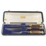 A cased three piece carving set, comprising : knife with serrated blade,