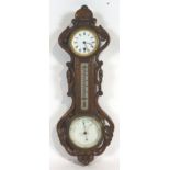 A 19th century wall barometer, the oak case carved with pierced acanthus scroll work,