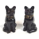 A pair of glazed terracotta figures of sejant cats, wearing bow ties,