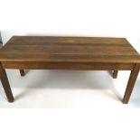 A rectangular oak table with triple plank top on square tapering legs,