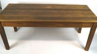 A rectangular oak table with triple plank top on square tapering legs,