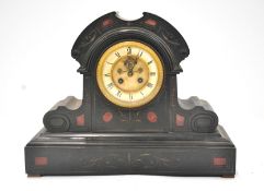 A black slate dome topped clock with side brackets, on a plinth, inlaid with red stone accents,