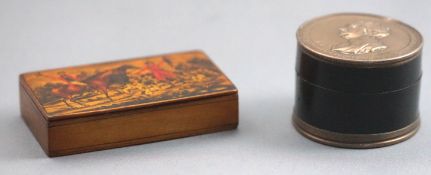 A composition two piece round form snuff box set to the top and base with panels commemorating