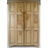 A pine two door cupboard, each door with six panels,