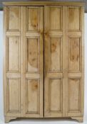 A pine two door cupboard, each door with six panels,