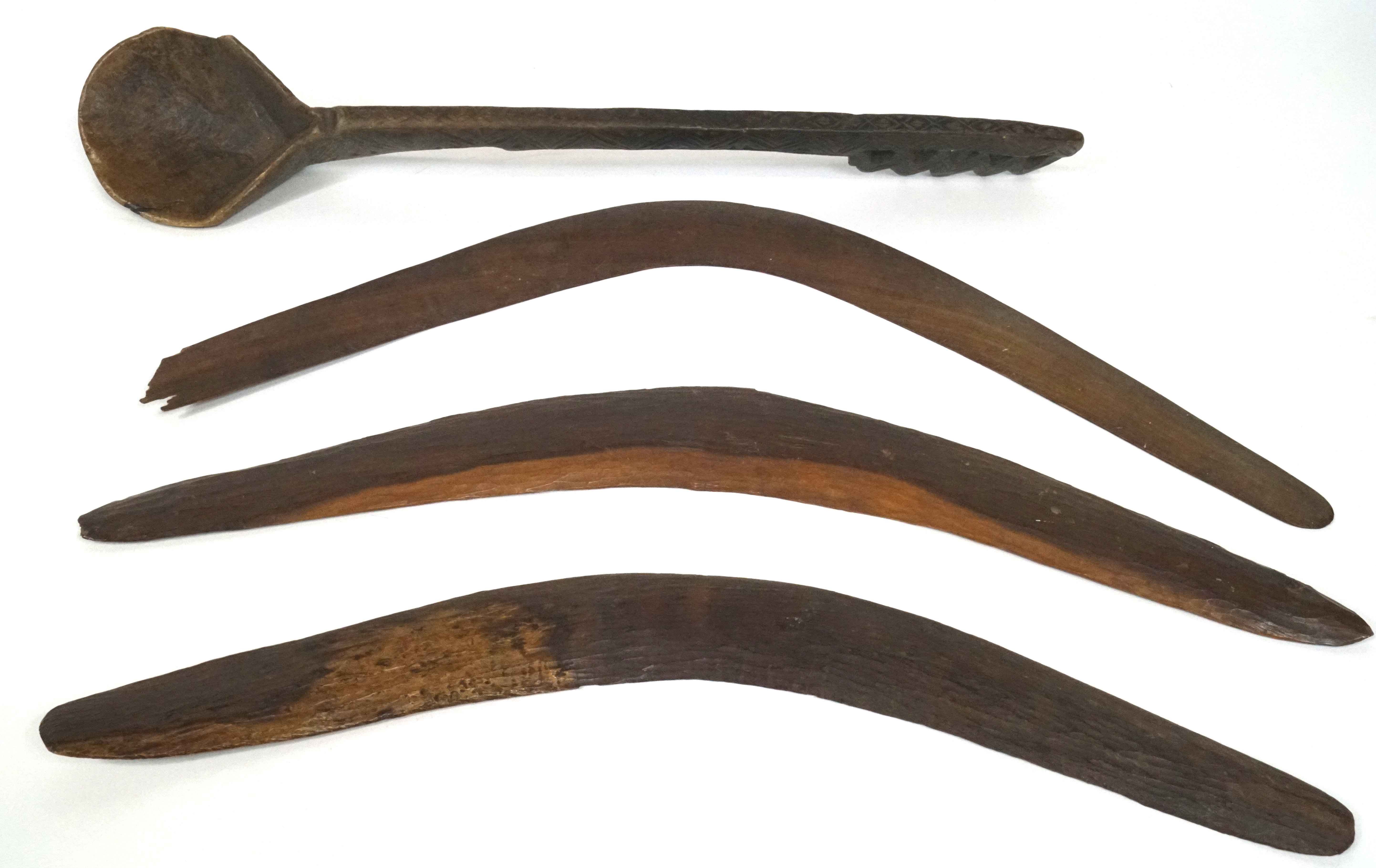 Three Australian Aboriginal boomerangs, two with incised linear ornament,