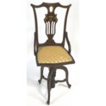 An Edwardian mahogany and marquetry swivel office desk chair on three scroll legs,