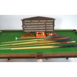 An early 20th century slate bed half size snooker table on an oak base with baluster turned legs,