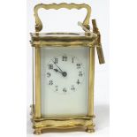A French brass eight day carriage clock, of serpentine form,