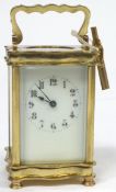 A French brass eight day carriage clock, of serpentine form,