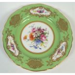 A Royal Worcester Sevres style cabinet plate with a central polychrome floral panel of roses,