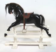 An Edwardian black painted wood rocking horse, early 20th century,