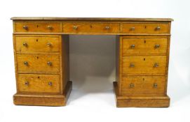 A Victorian oak pedestal desk with leather inset top above three drawers,