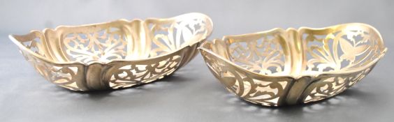 A pair of small silver cake baskets, of shaped oval form,