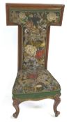 A Victorian mahogany prie dieu chair with needlework and beadwork back and seat on cabriole legs