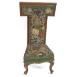 A Victorian mahogany prie dieu chair with needlework and beadwork back and seat on cabriole legs