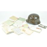 A Third Reich painted metal military helmet, with a pressed white metal cap badge,